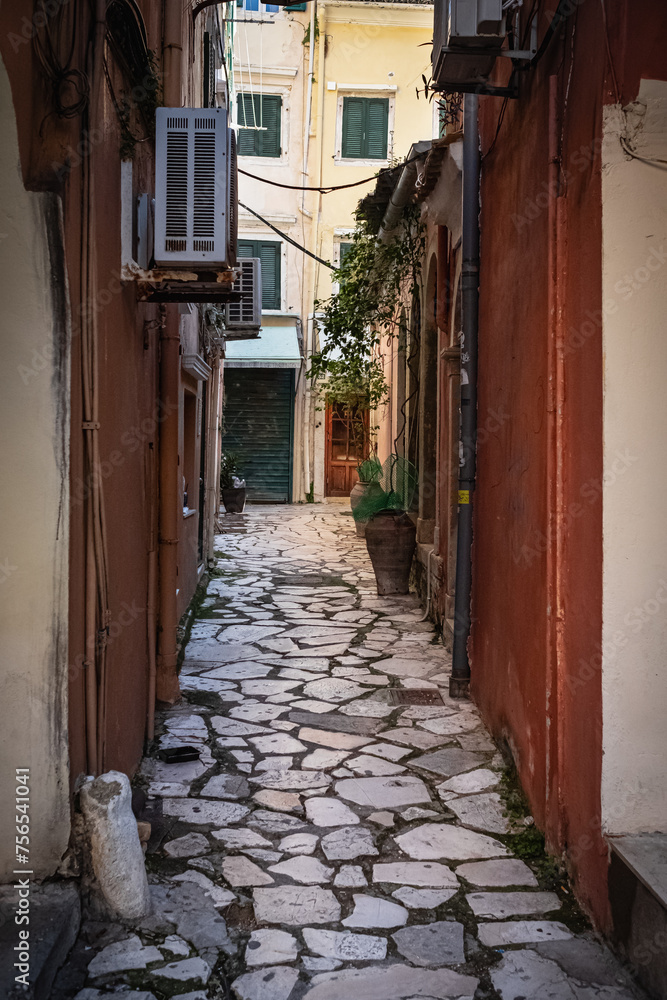 Narrow street in the old town in Corfu Greece. Alley in a small Mediterranean village