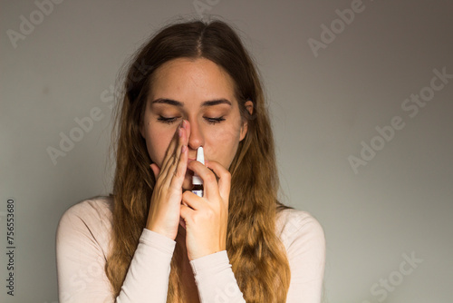 Cold. Beautiful Woman Using Nasal Spray