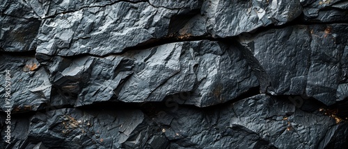 The background is black and white stone rock granite. Dark gray. Grunge. Mountain surface texture. Landscape. Close-up. Volumetric. Rocky. Backdrop. Wide banner. The view is panoramic.