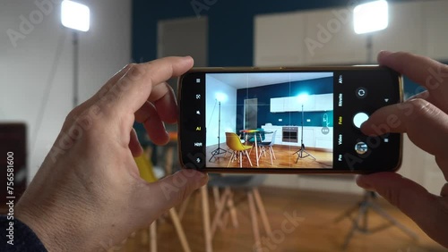 RReal estate photographer taking pictures and videos  at house  in apartment living room with mobile phone  - selling home with real estate agency and home staging indoor home design photo