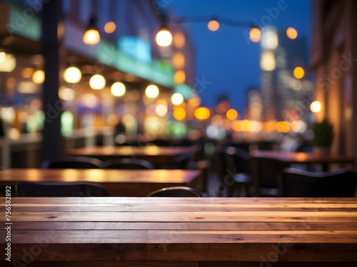 Wooden cafe table bokeh background, empty wood desk, restaurant tabletop counter in a bar or coffee shop surface product display mockup with blurry city lights backdrop presentation. Mock-up © Mahmud