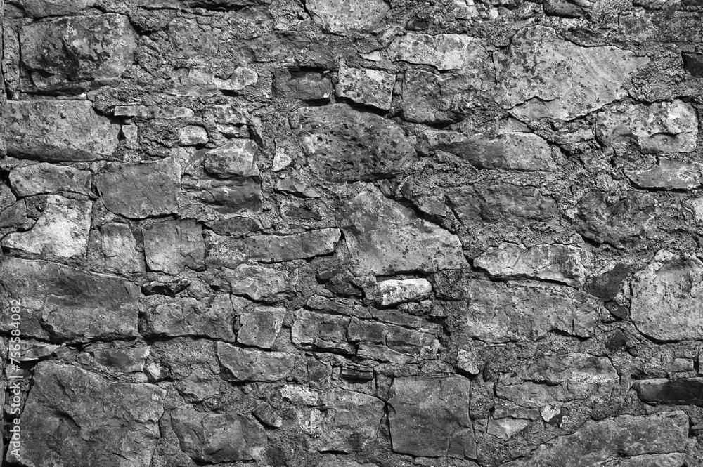 Obraz premium in the photo there is an old gray stone wall close up