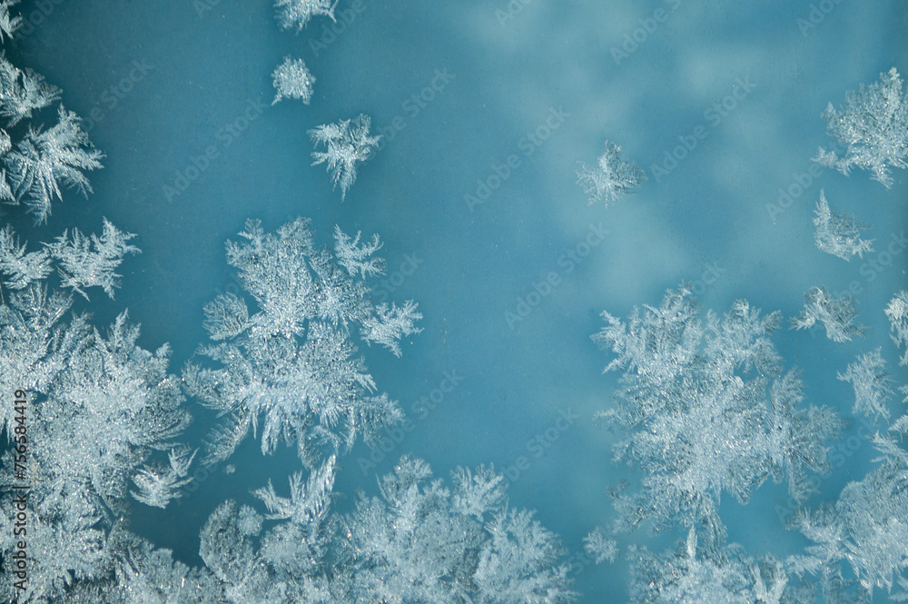 ice pattern on glass and blue background ice pattern on glass and blue background