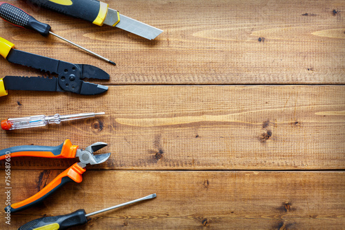 A set of hand tools on a wooden background. The concept of repair work. Copy space photo