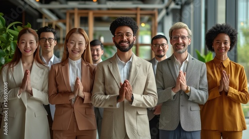 Diverse Team Celebrating Unity, group of seven diverse professionals in smart casual attire stands together, hands clasped in a gesture of gratitude and unity in a modern workspace