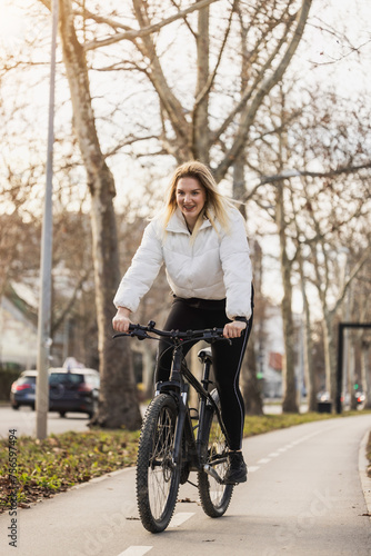 Woman Riding Bike Down a City Street