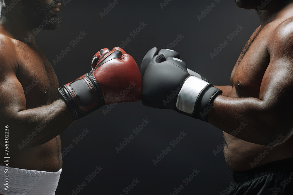 Side view close up of two fighters bumping boxing gloves before fight in ring, copy space