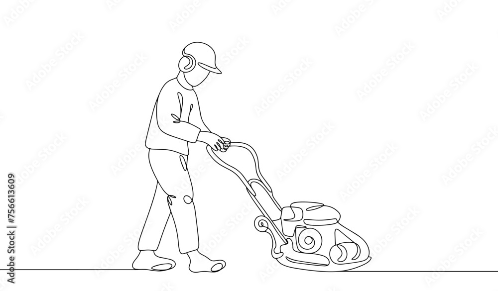 A road worker compacts the soil using a vibrating plate A road worker compacts the soil using a vibrating plate
