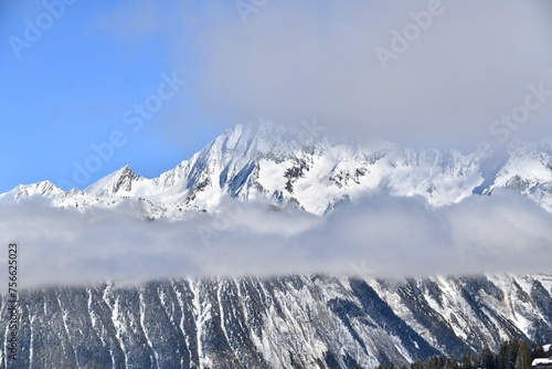 snow covered mountains with a cloud 