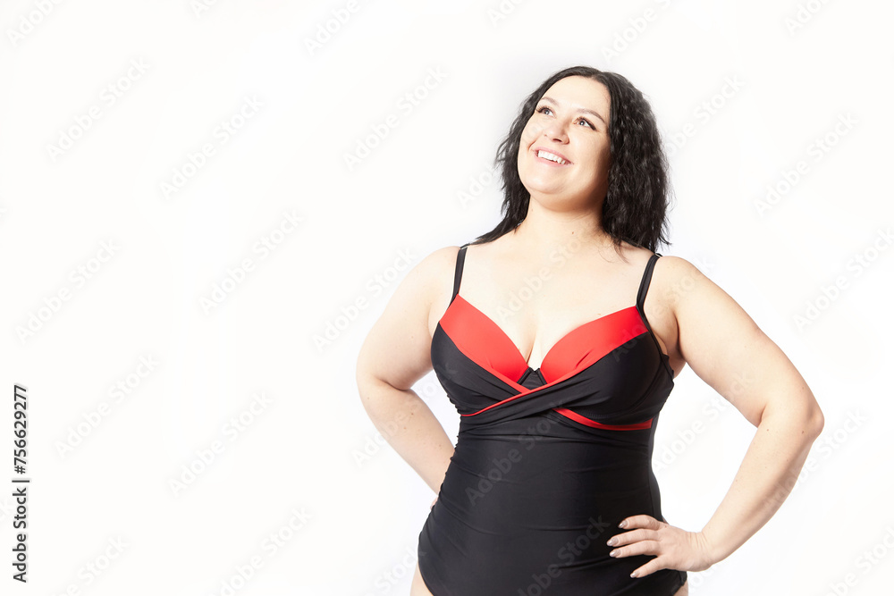 Portrait of attractive dreamy thick woman in red black swimsuit posing on white background. Body positive, photo shoot, selfie. Funny plus size model Portrait of attractive dreamy thick woman in red black swimsuit posing on white background. Body positive, photo shoot, selfie. Funny plus size model