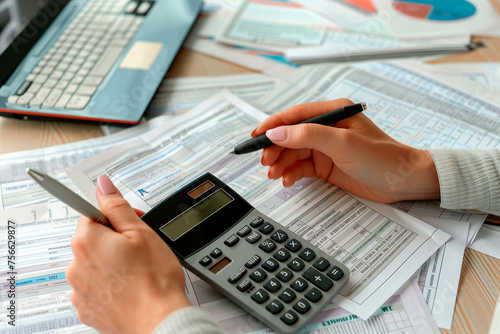 Accounting. Business woman hands with calculator and documents at office
