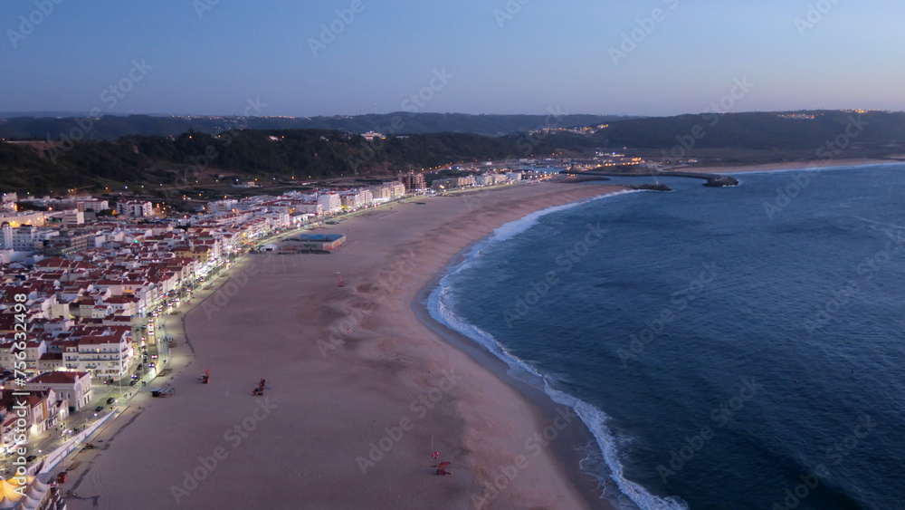 Sunset in Praia da Vila Nazaré, the busiest beach on the west coast and one of the most traditional fishing villages in Portugal         
