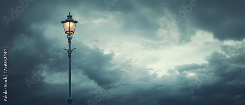 a street lamp with cloudy sky as background .. photo