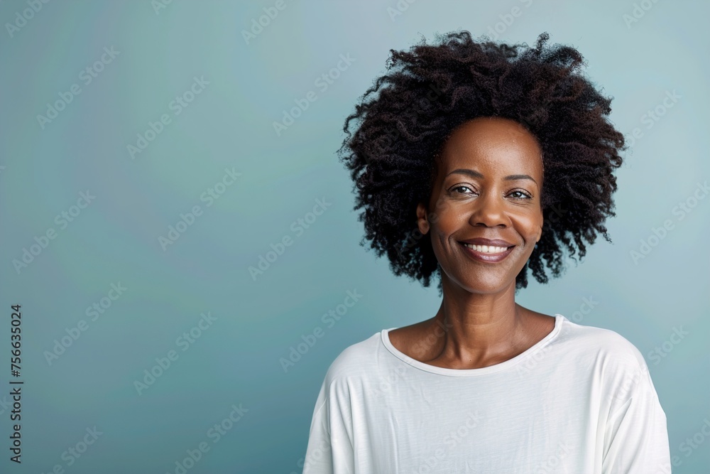 A woman with curly hair is smiling and wearing a white shirt A woman with curly hair is smiling and wearing a white shirt