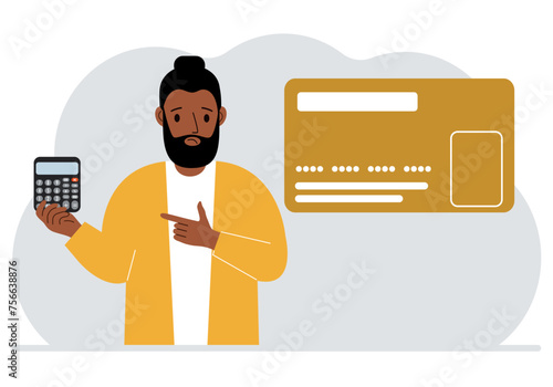 A man holds a calculator in his hand. Nearby is a large plastic card.