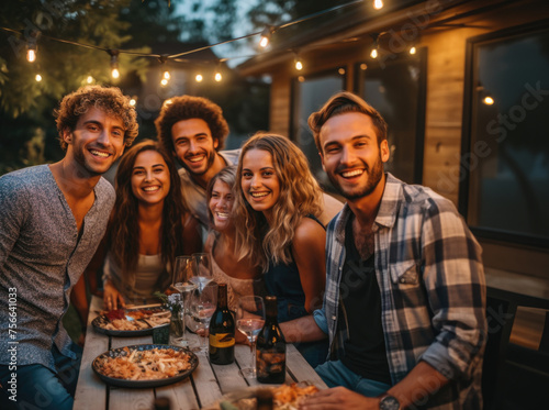 Young people dining and having fun drinking red wine together outdoor at dinner party
