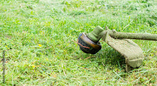 Trimmer close up mow the grass with a lawnmower .Gardening with a brush cutter Close-up. Lawn care with brush cutters photo