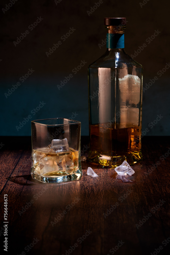 Glass whisky on ice with piece of orange Glass whisky on ice with piece of orange