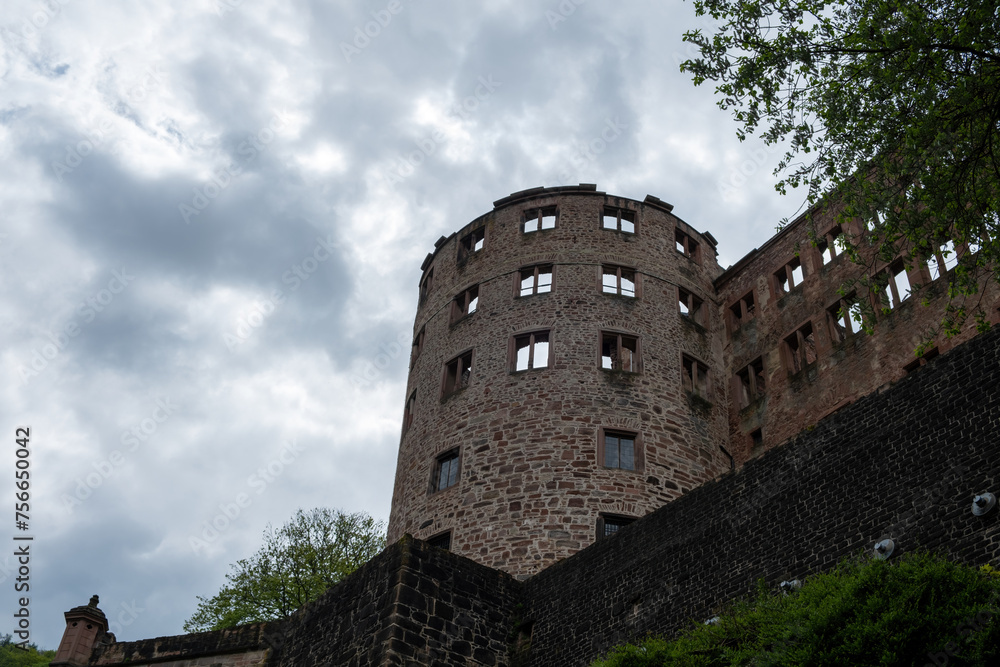 Heidelberg castle tower, Germany nature. Under view of old fortress ruins, cloudy sky background.