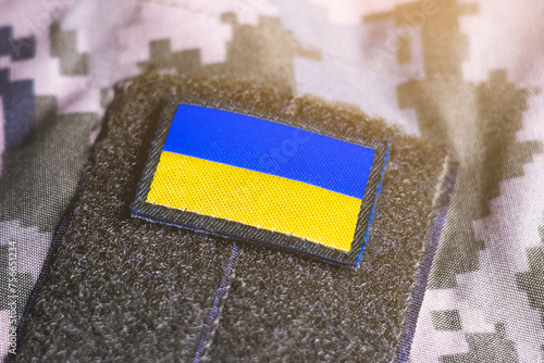 Close up khaki camouflage amunition. Armed Forces of Ukraine. Ukrainian army. Ukrainian flag on military uniform. photo