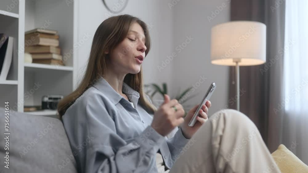 Portrait of beautiful young woman having video call conference meeting by smartphone laying on couch at home Smiling confident female talking on personal conversation Distance relationships Portrait of beautiful young woman having video call conference meeting by smartphone laying on couch at home Smiling confident female talking on personal conversation Distance relationships