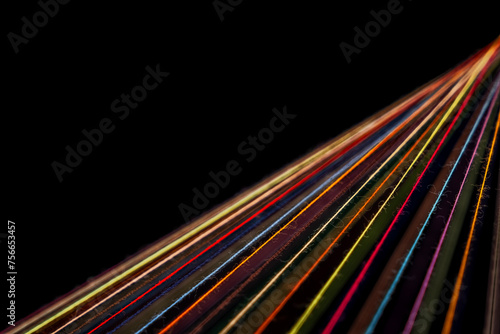 Converging Multi-colored Sewing Thread on a black background