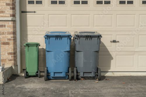 Garbage cans near garage doors