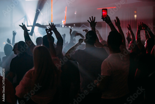 crowd of people dancing in concert