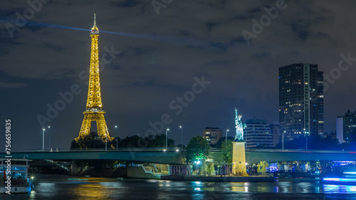 The small Statue of Liberty located near the Eiffel tower night timelapse. Paris, France
