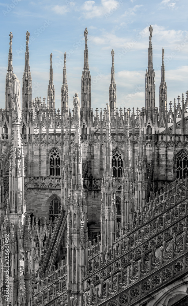 Fototapeta premium The famous Milan Cathedral (Duomo di Milano) on the Piazza del Duomo in Milan, Italy. Details on the roof