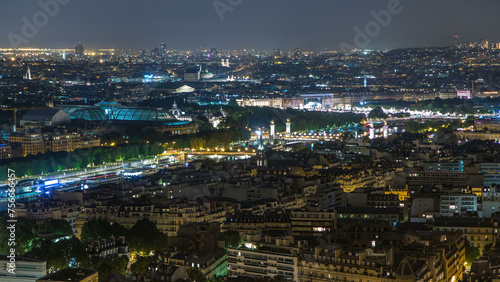 Aerial night timelapse view of Paris City and Seine river shot on the top of Eiffel Tower