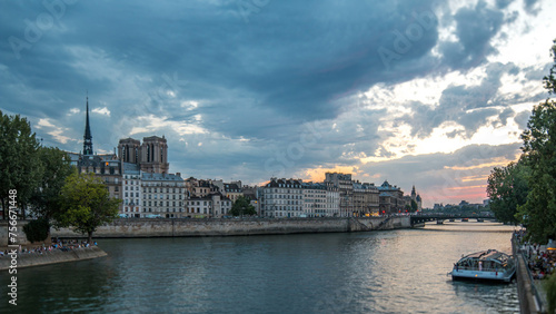 Le Pont D'Arcole bridge after sunset with people and boats day to night timelapse, Paris, France, Europe