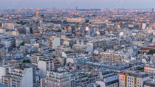 Aerial panorama above houses rooftops in a Paris day to night timelapse