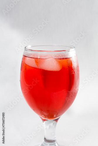 Red colored drink in a glass with ice macro photography as per likes of Rooh Afza and Jam e Shirin photo