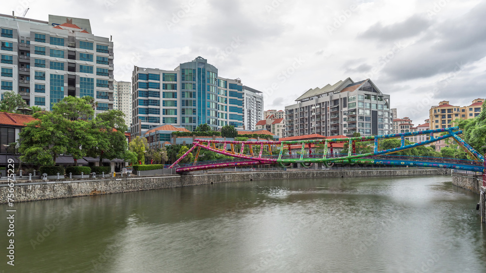 Alkaff Bridge on the Singapore River at Robertson Quay with dark gray clouds timelapse hyperlapse