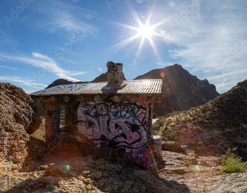 Graffiti building and desert mountains