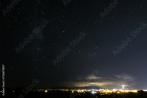 Starry Sky Cityscape with Lightning