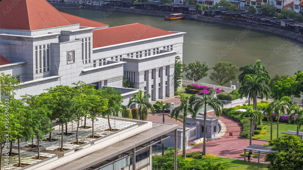 Parliament House in downtown Singapore aerial timelapse and boat quay in the background.