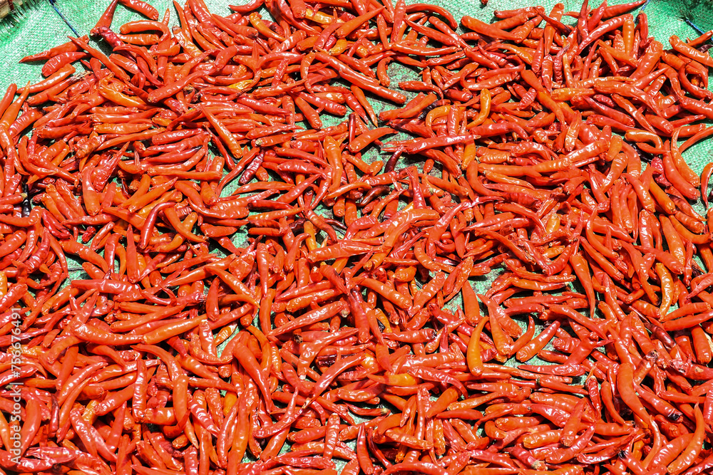 many red peppers or chili peppers on a green surface