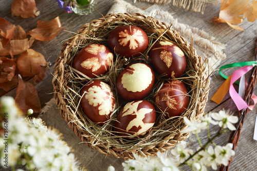 Wallpaper Mural Brown Easter eggs dyed with onion skins in a basket with spring flowers, top view Torontodigital.ca