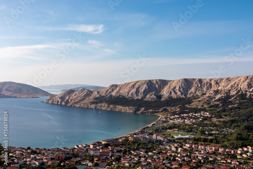 Fototapeta Naklejka Na Ścianę i Meble -  Panoramic aerial view of idyllic coastal town Baska, Krk Island, Primorje-Gorski Kotar, Croatia, Europe. Coastline of Mediterranean Adriatic Sea surrounded by karst mountains. Archipelago Kvarner Bay