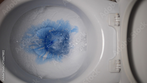Experience the process of applying blue toilet cleaner into the toilet bowl, promoting germ-free and fresh restroom. Elevate your hygiene standards with this effective sanitation solution