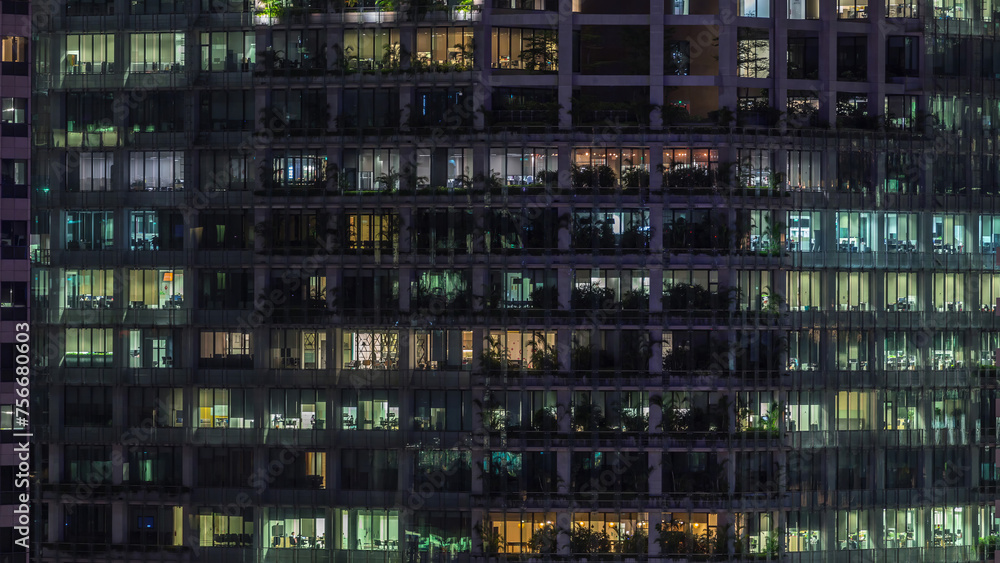 Modern office building with big windows at night timelapse, in windows light shines Modern office building with big windows at night timelapse, in windows light shines