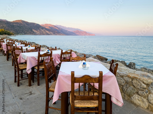 Outdoors traditional seaside taverna restaurant, Paleochora village afternoon in Crete island Greece