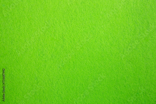 Felt fabric texture with visible fiber, toxic green color abstract pattern backdrop, close up texture