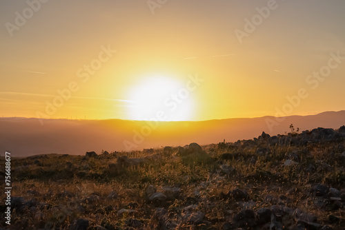 Dramatic sunrise seen from mountain peak Hlam at the moon plateau in Baska  Krk Island  Primorje-Gorski Kotar  Croatia  Europe. Idyllic hiking trail on deserted barren rock landscape in sunny summer