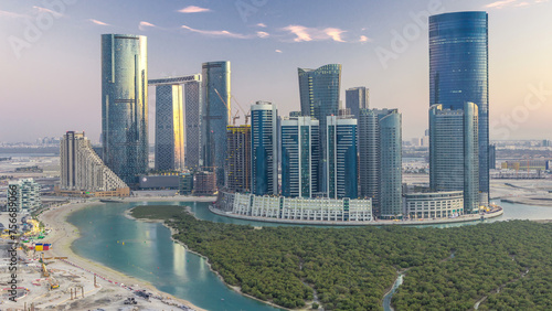 Buildings on Al Reem island in Abu Dhabi day to night timelapse from above.