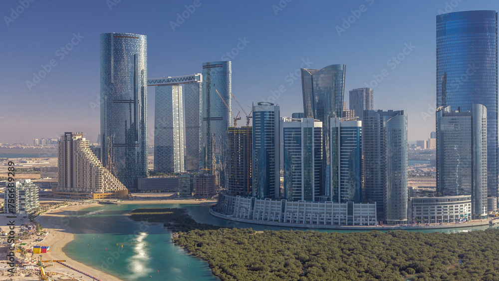 Fototapeta premium Buildings on Al Reem island in Abu Dhabi timelapse from above.