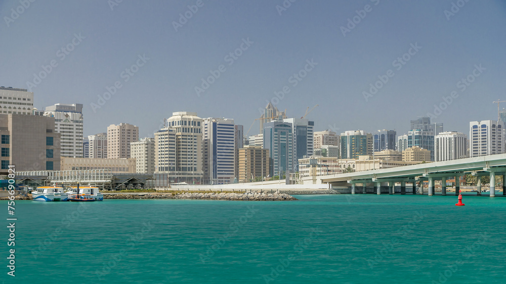 Modern buildings in Abu Dhabi skyline timelapse with mall and beach.