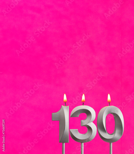 Candle number 130 - Birthday celebration on fuchsia background